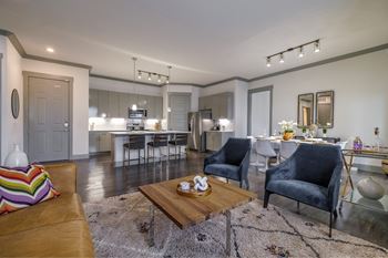spacious, open-concept kitchen and living room at Reveal Skyline apartments
